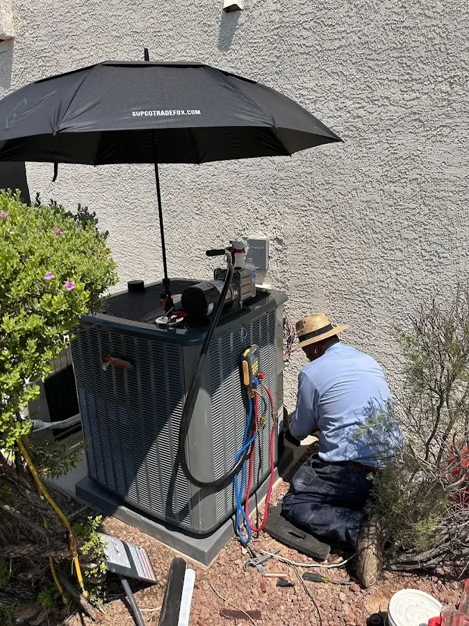HVAC technician performing outdoor AC maintenance in Plainfield